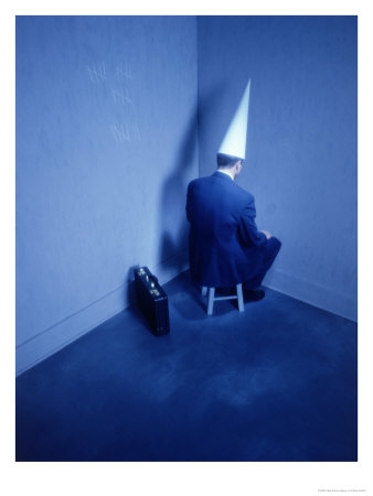 386410a~Businessman-Sitting-in-Corner-with-Dunce-Hat-Posters.jpg