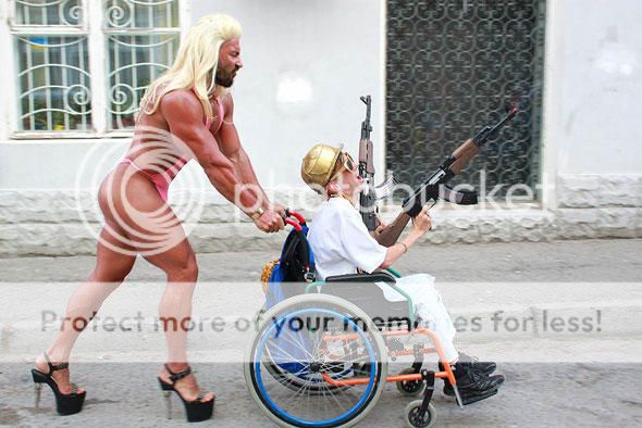 funny-wtf-wheelchair-gun-cross-dress.jpg